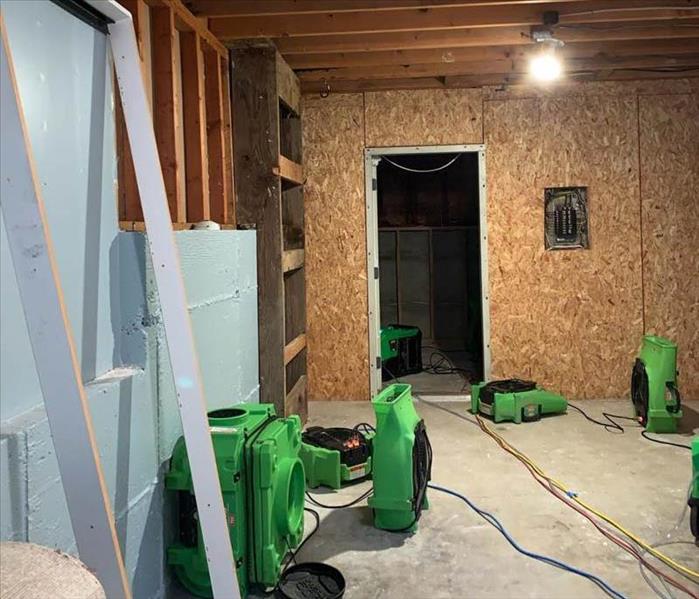 Water damaged basement with air movers
